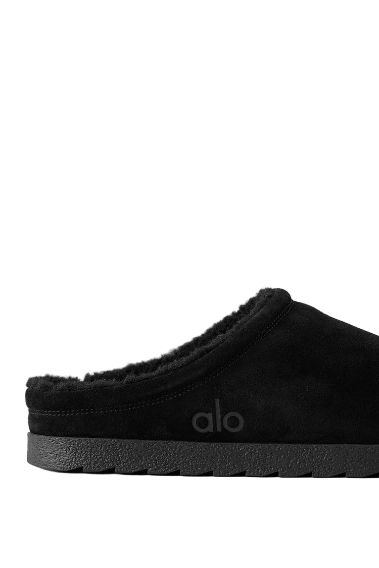 Alo Recovery Slipper in the black suede color with a faux fur lining.