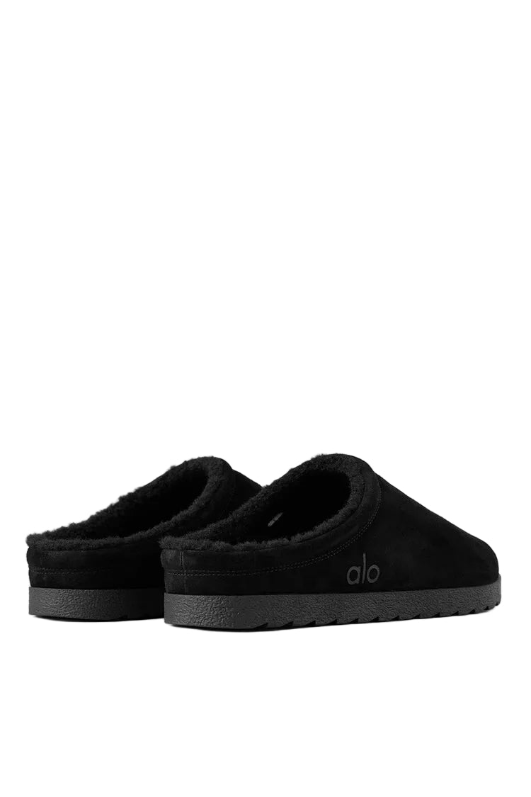 Alo Recovery Slipper in the black suede color with a faux fur lining.