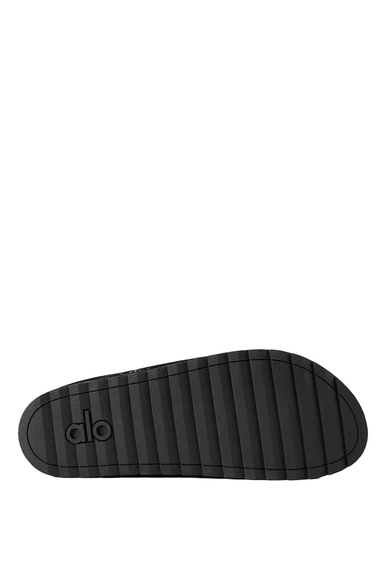 Alo Recovery Slipper in the black suede color with a faux fur lining.