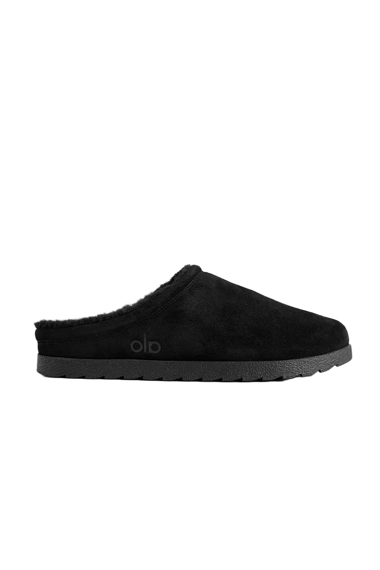 Alo Recovery Slipper in the black suede color with a faux fur lining.